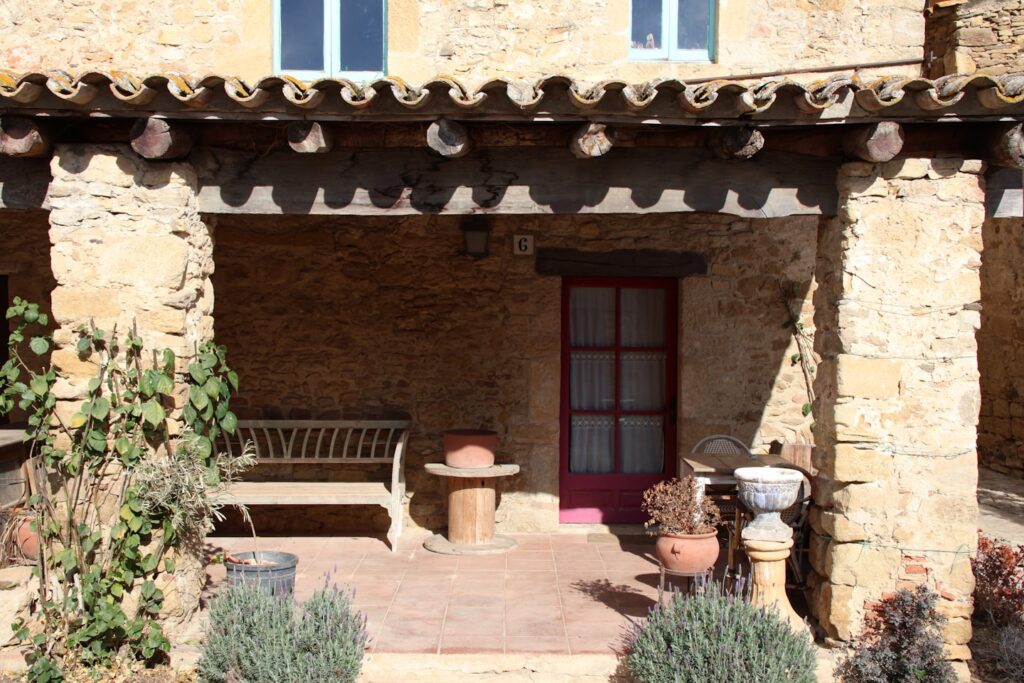 Step into history as you cross the threshold of the porch of a traditional Catalan masia. This iconic feature of rustic charm and architectural heritage welcomes visitors with its weathered beams and time-worn stones, embodying the essence of Catalonia's rich cultural legacy. From its shaded alcoves to its worn wooden benches, the porch whispers stories of generations past, inviting you to linger and savor the timeless beauty of rural Catalonia